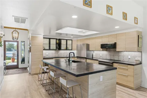 a kitchen with stainless steel appliances granite countertop a sink counter space and cabinets