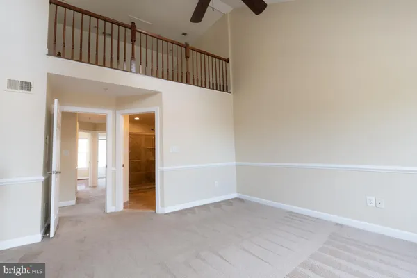 a view of a bedroom with wooden floor and windows