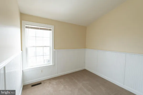 a view of an empty room and closet area