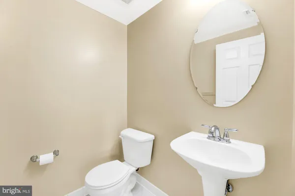 a bathroom with a sink a mirror and a toilet