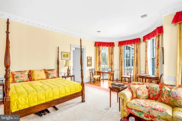 a view of a house with a yard balcony and sitting area