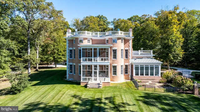 a view of a house with pool and chairs