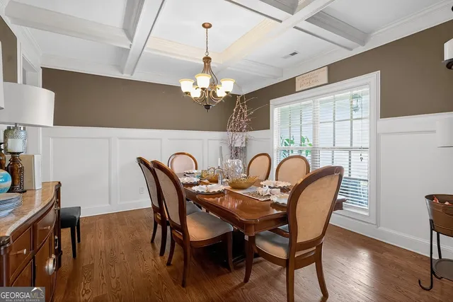 a view of a dining room with furniture wooden floor and chandelier