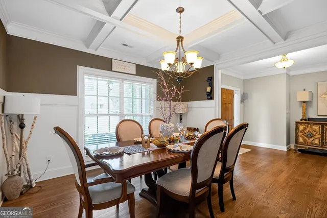 a view of a dining room with furniture and chandelier