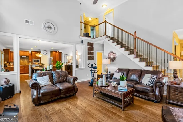a living room with furniture and wooden floor