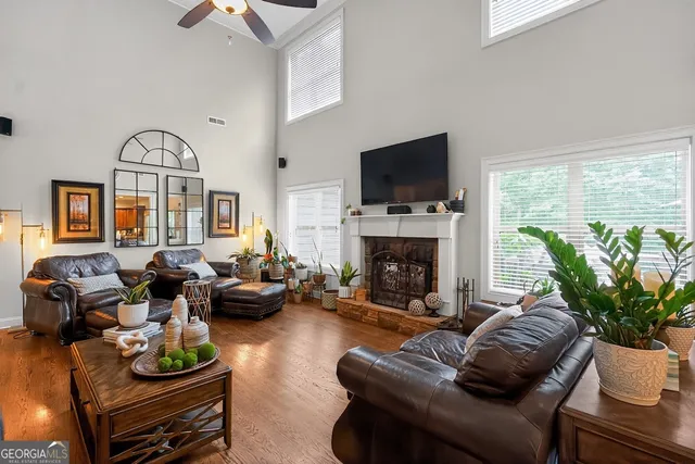 a living room with furniture fireplace and a flat screen tv
