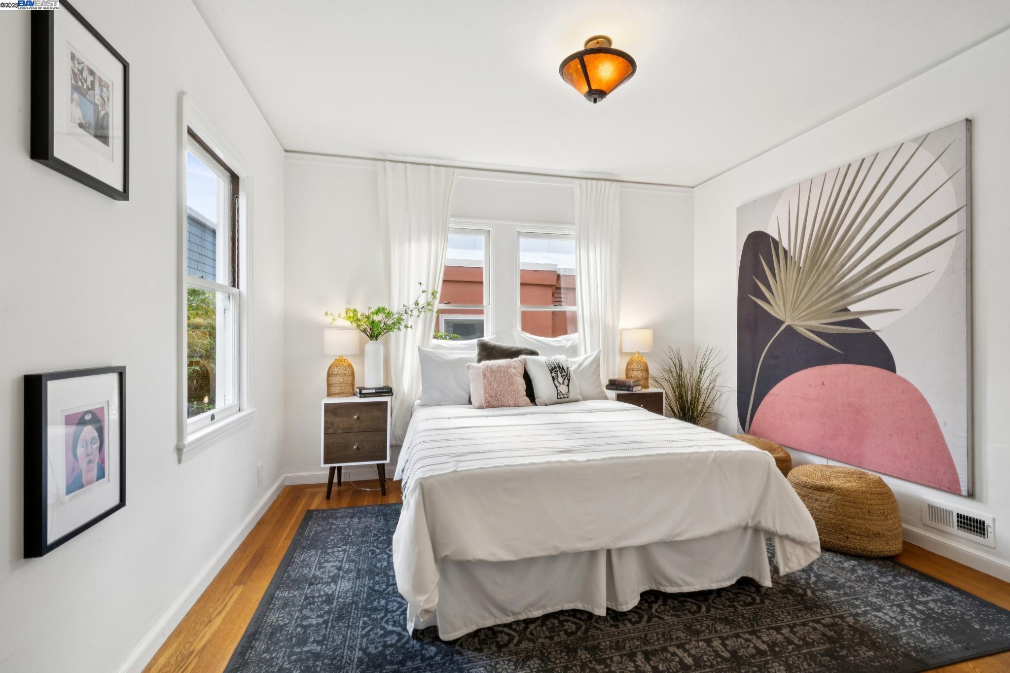 3047 Halcyon Court Berkeley, CA 94705 - Photo 25 of 45 a bedroom with a bed lamps and wooden floor