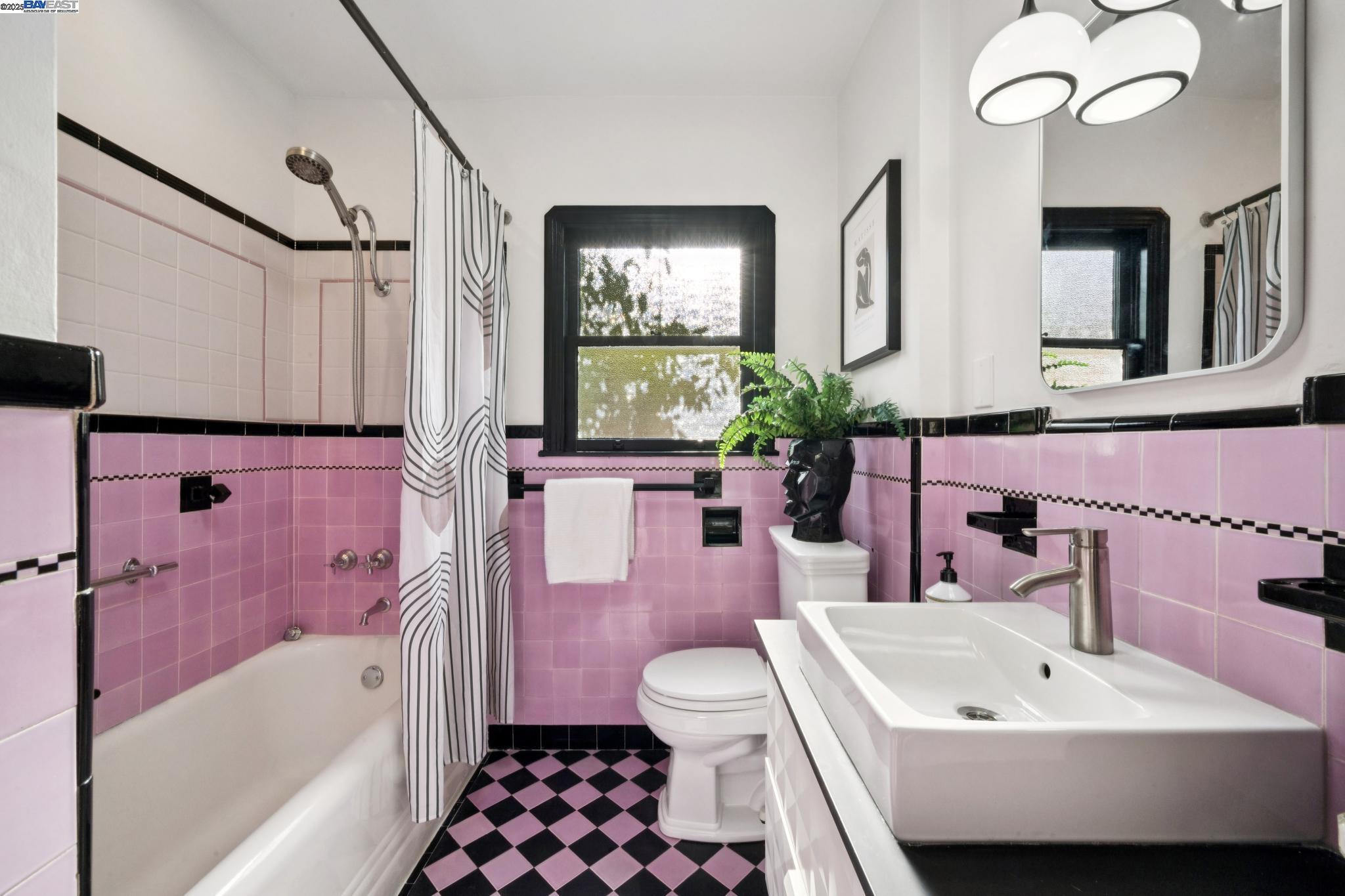 3047 Halcyon Court Berkeley, CA 94705 - Photo 26 of 45 a bathroom with a sink a toilet a mirror a vanity and bathtub