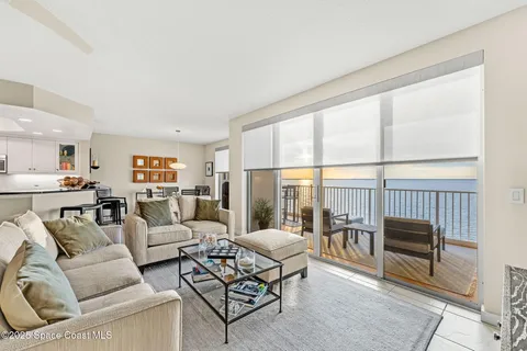 a living room with furniture a dining table and a fireplace
