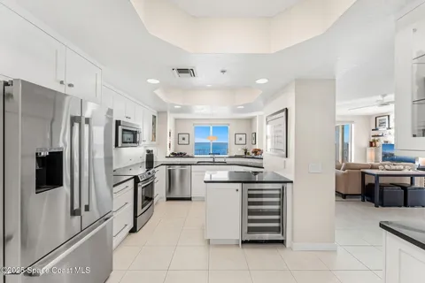 a view of kitchen with granite countertop stove top oven and cabinets