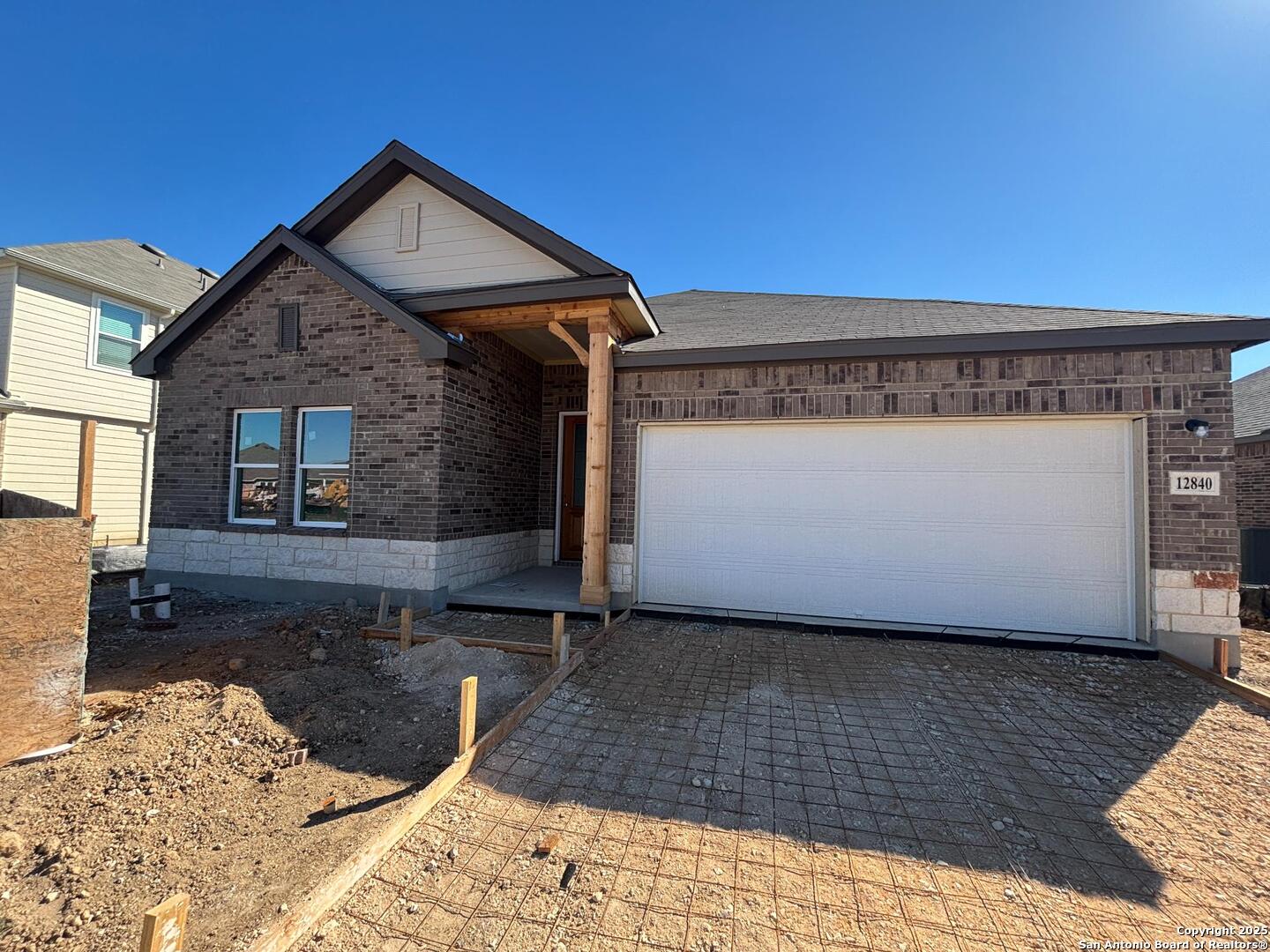 a view of a house with wooden fence