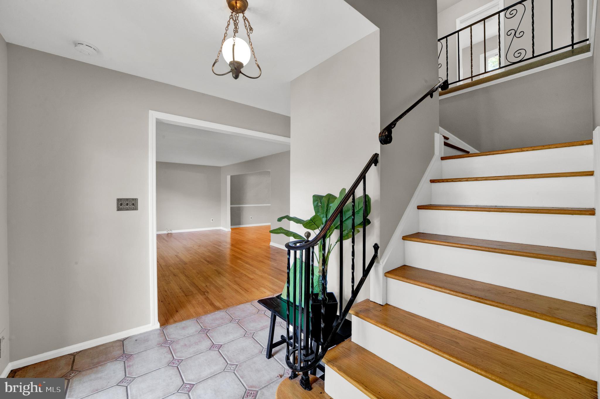 382 Burnt Hill Road Skillman, NJ 08558 - Photo 5 of 49 a view of staircase with wooden floor and a potted plant