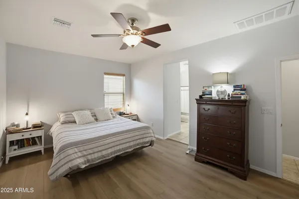 a bedroom with a bed and a large window
