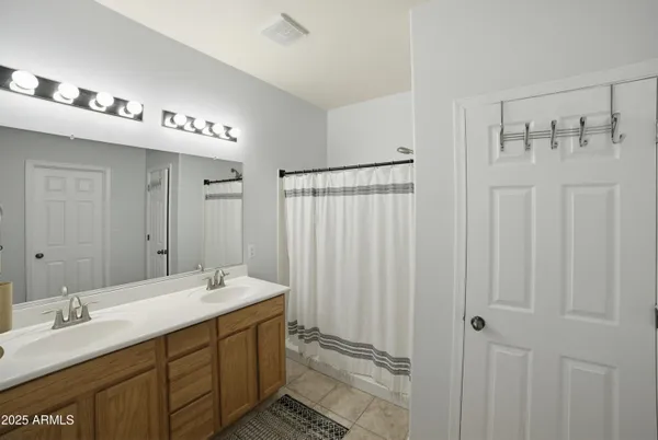 a white toilet sitting next to a white sink and vanity