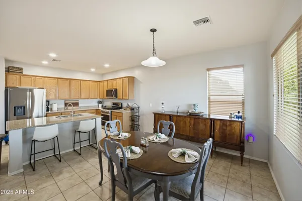 a kitchen with counter space appliances and a dining table
