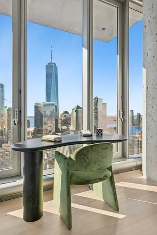 a bedroom with a large window and a bed