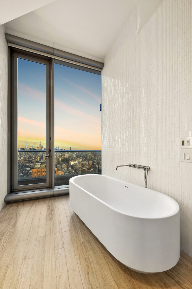 56 Leonard Street, Unit 47WEST Manhattan, NY 10013 - Photo 4 of 13 a white bath tub sitting in a bathroom next to a window