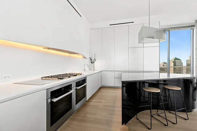 a living room with furniture a dining table and a potted plant