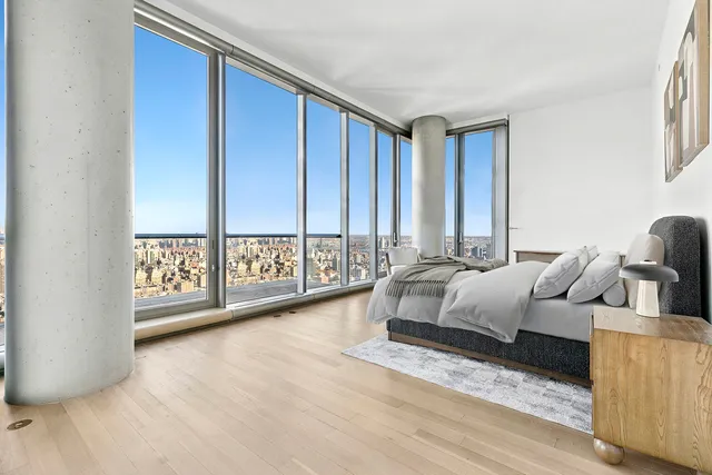 a bedroom with furniture and a large window