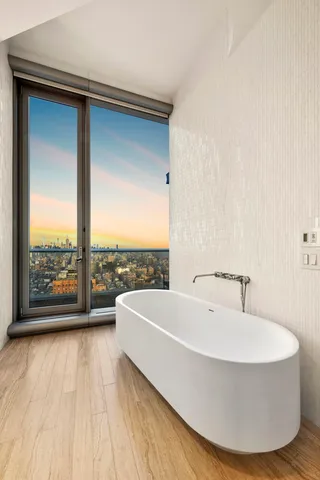 a spacious bedroom with a large bed and a large window