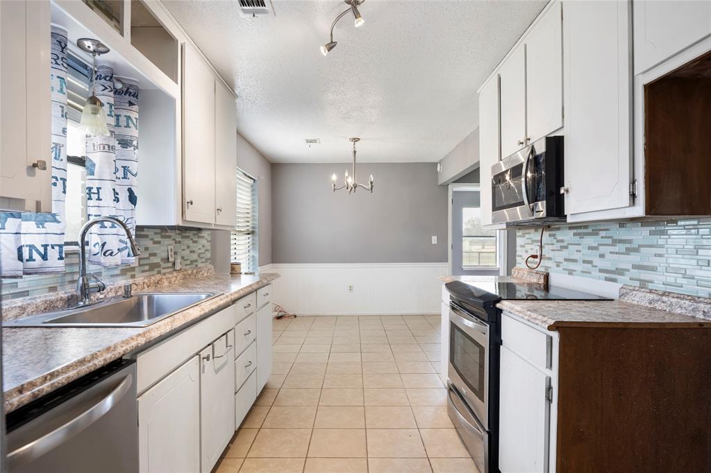 1106 HCR 1414 Covington, TX 76636 - Photo 13 of 37 a kitchen with a sink and cabinets