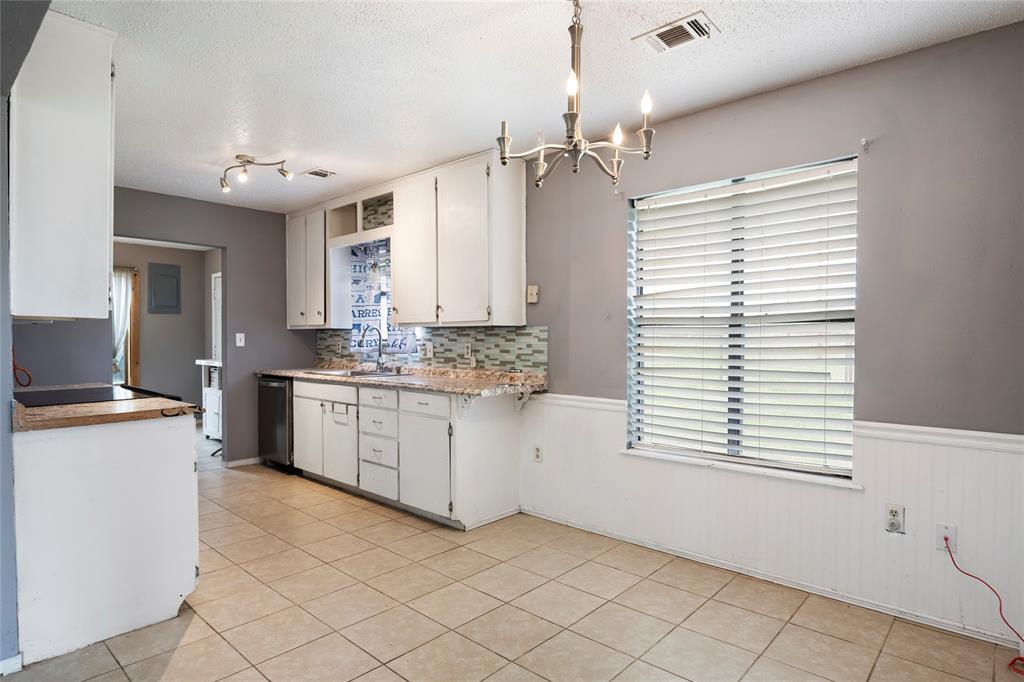 1106 HCR 1414 Covington, TX 76636 - Photo 15 of 37 a kitchen with a cabinets and white appliances
