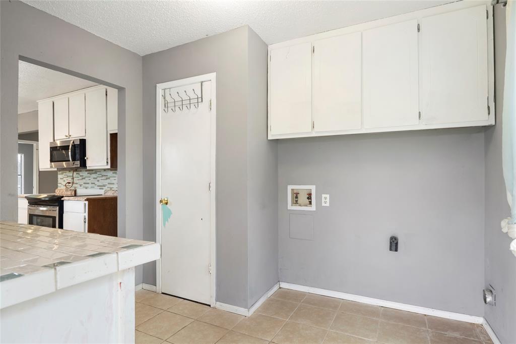 1106 HCR 1414 Covington, TX 76636 - Photo 18 of 38 a view of a kitchen with granite countertop cabinets