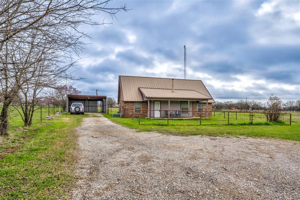 1106 HCR 1414 Covington, TX 76636 - Photo 2 of 37 a view of a big house with a big yard and large trees