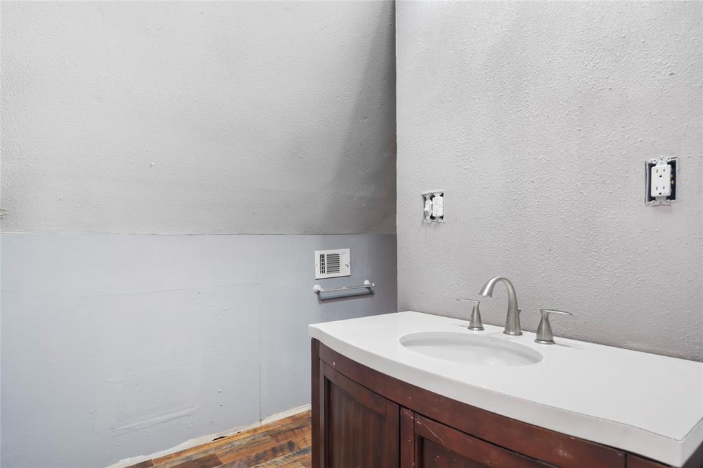 1106 HCR 1414 Covington, TX 76636 - Photo 27 of 37 a close up of a sink and a mirror