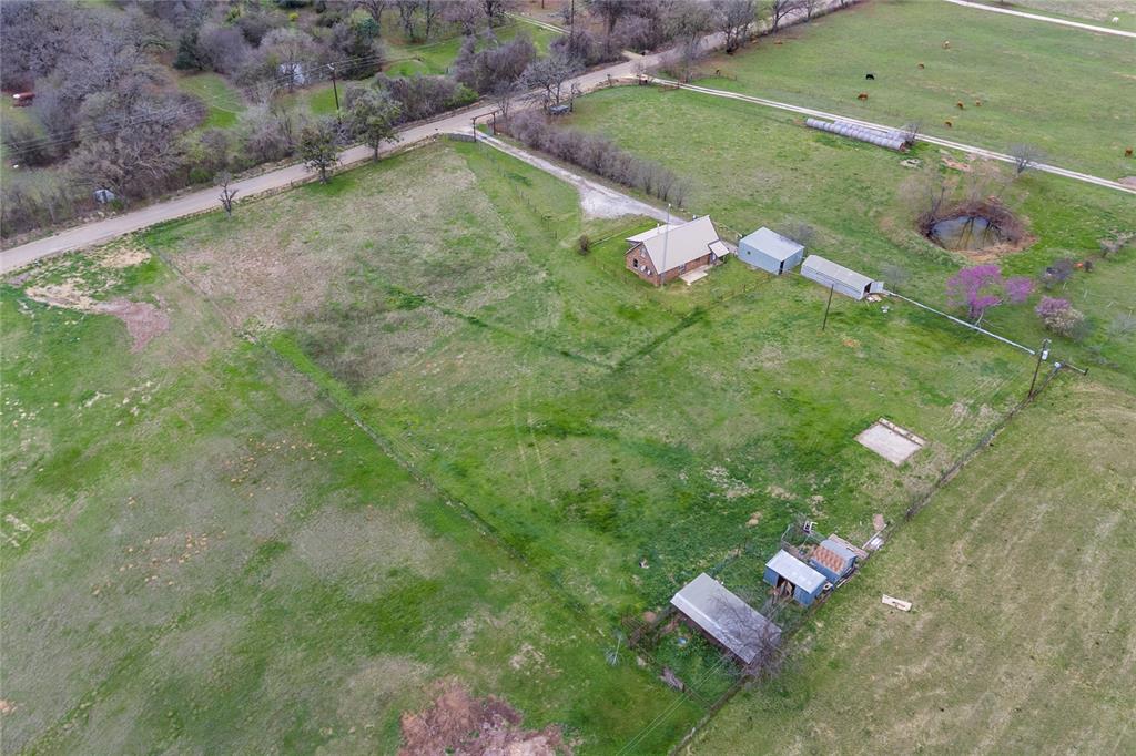 1106 HCR 1414 Covington, TX 76636 - Photo 32 of 37 a backyard of a house with a yard and potted plants