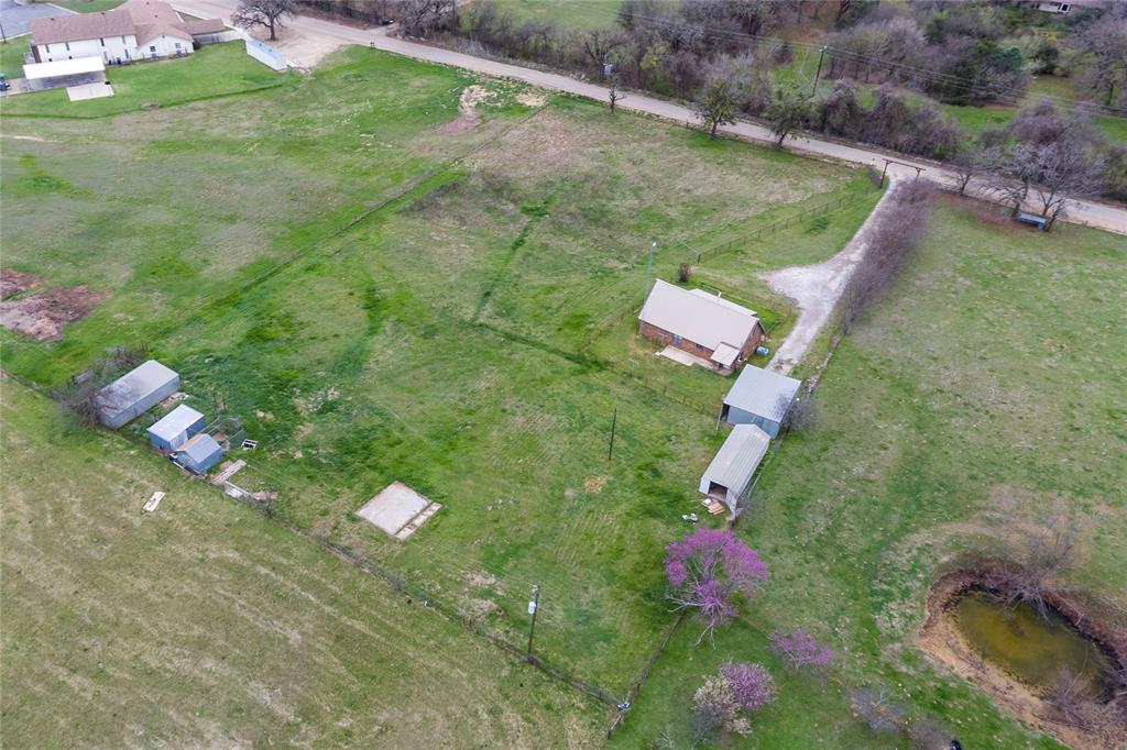 1106 HCR 1414 Covington, TX 76636 - Photo 34 of 38 an aerial view of a house with a yard