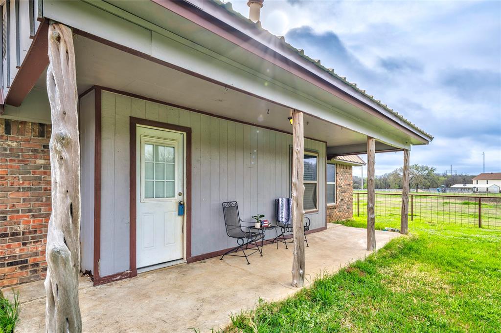 1106 HCR 1414 Covington, TX 76636 - Photo 7 of 37 a view of a patio with table and chairs under an umbrella