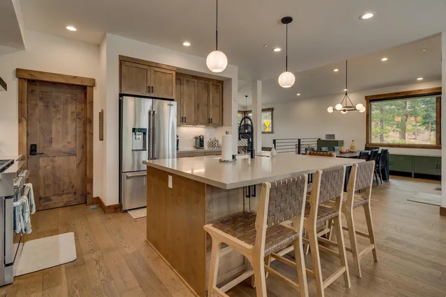 a kitchen with a refrigerator a sink and cabinets