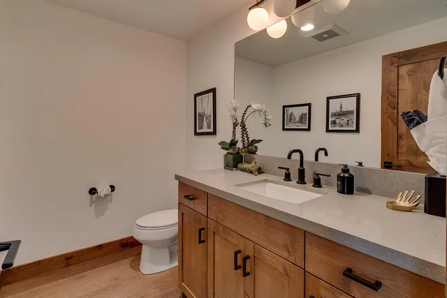a spacious bedroom with a bed and glass windows