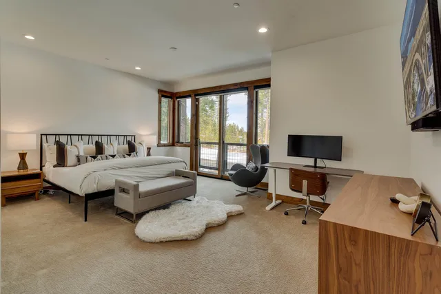 a spacious bathroom with a double vanity sink a large mirror and a bathtub