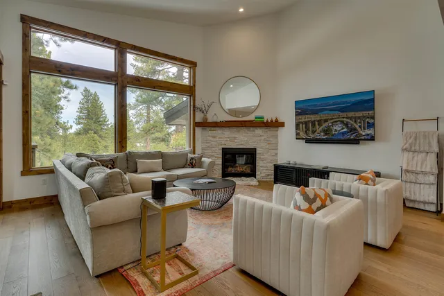 a living room with furniture a fireplace and kitchen view