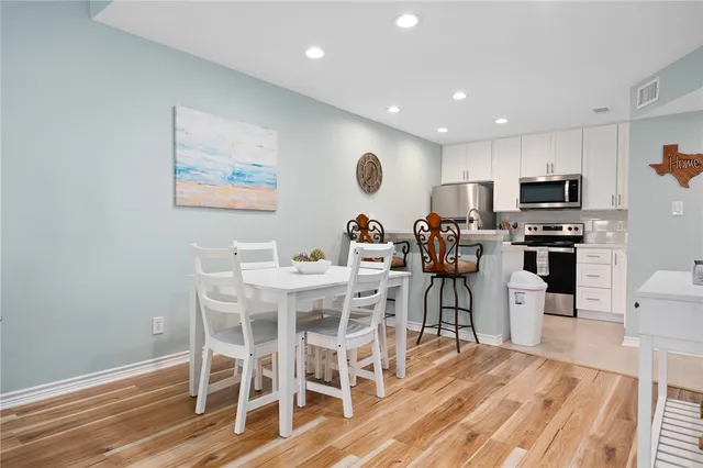 a view of a dining room with furniture and wooden floor