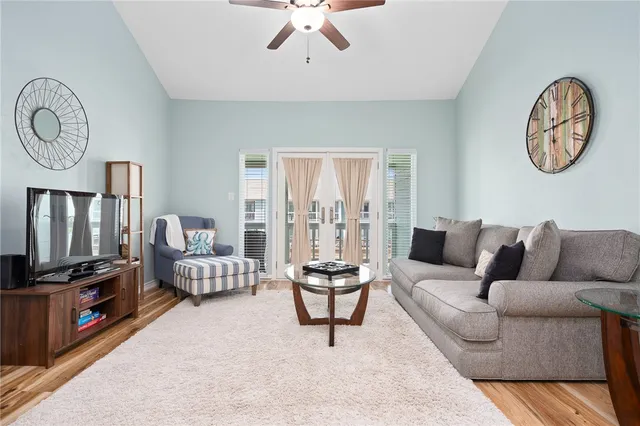 a living room with furniture a rug and a flat screen tv