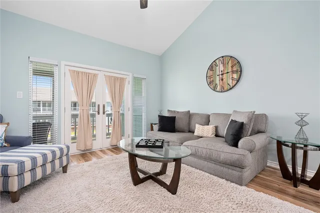 a living room with furniture a large window and a table