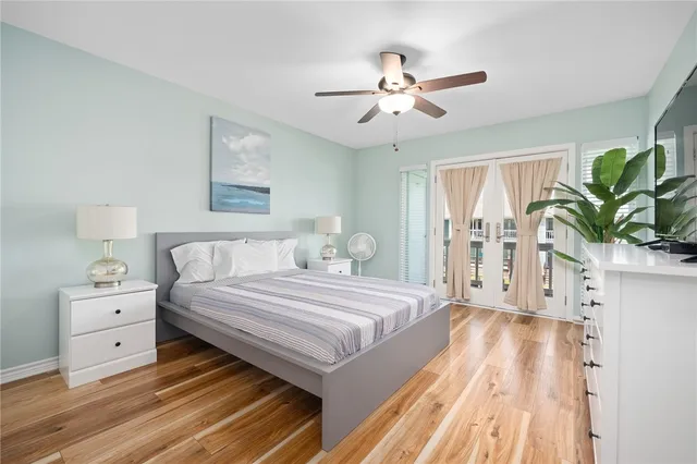 a spacious bedroom with a bed and a chandelier