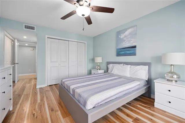 a spacious bedroom with a bed and a chandelier