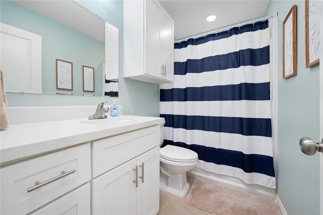 a bathroom with a sink a toilet a shower and mirror