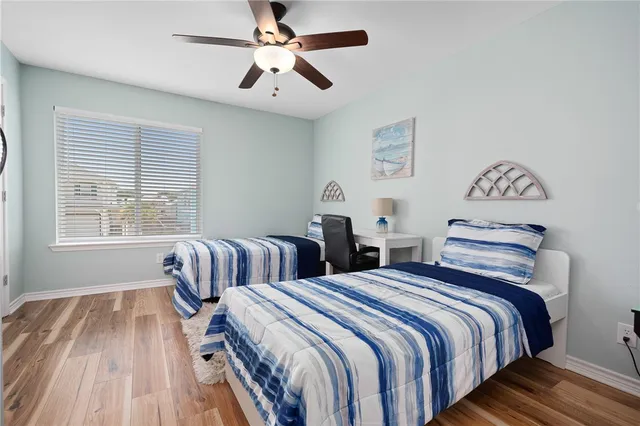 a bedroom with two beds and a chandelier