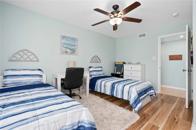 a bedroom with two beds and a chandelier