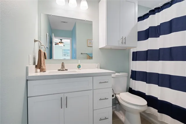 a bathroom with a sink a toilet a shower and a mirror