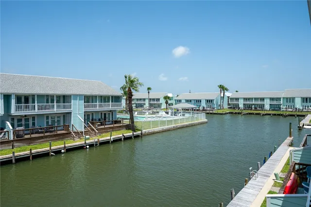 a view of an ocean with boats and trees in the background