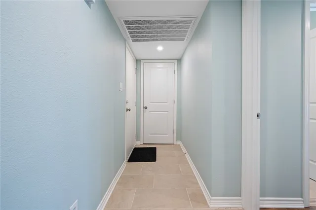 a view of hallway with windows