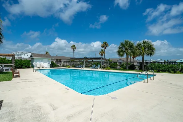 a view of a swimming pool with a yard