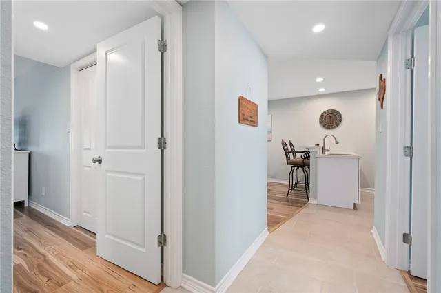 a view of a hallway with a chair and front door