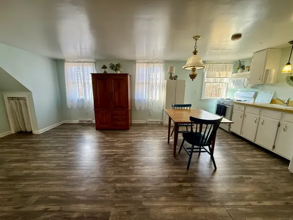 a view of a dining room with furniture and wooden floor